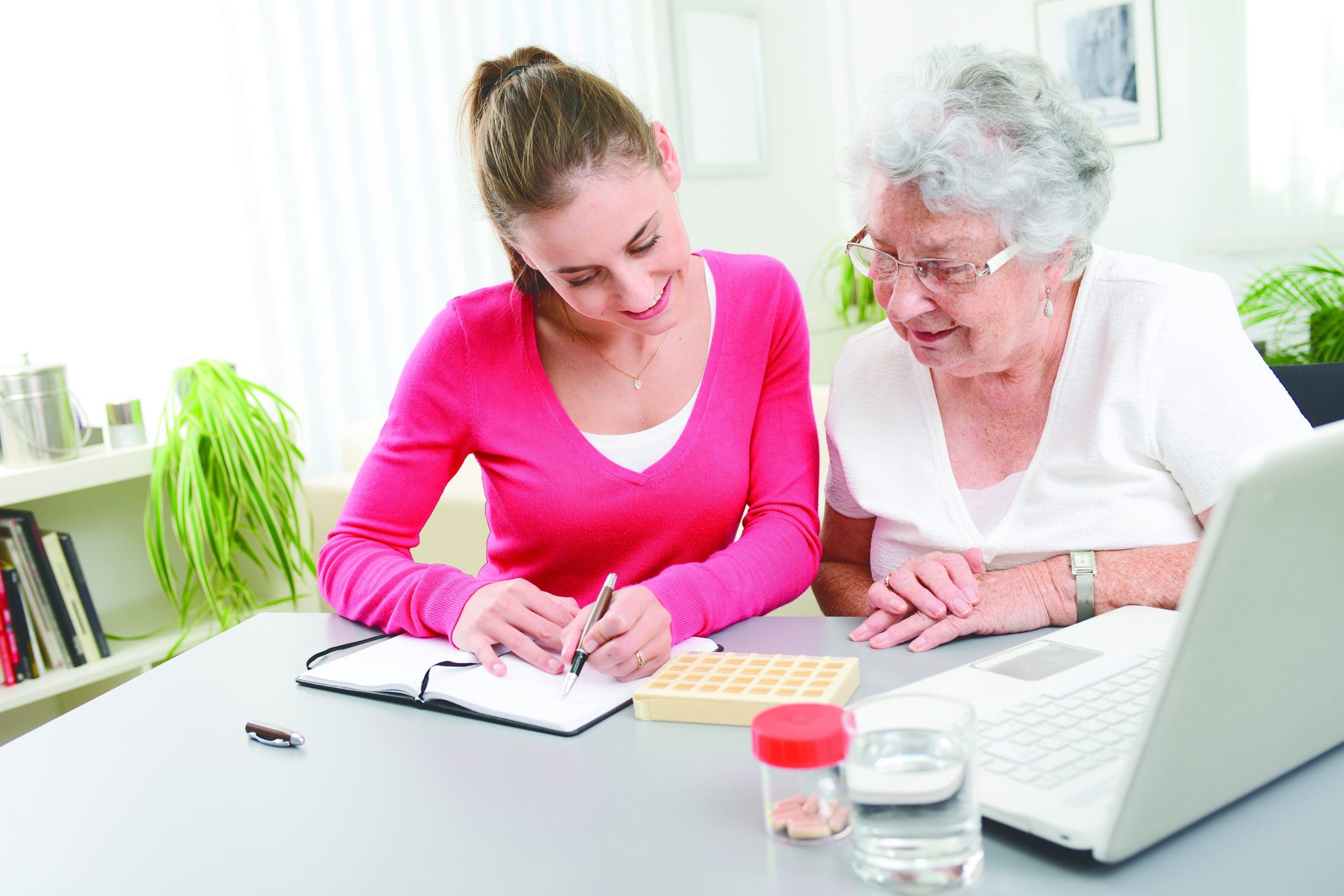 Cheerful,Young,Woman,Helping,An,Elderly,Woman,With,Pills,Medical