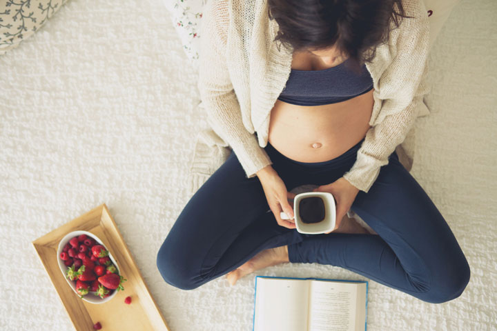 Pregnant woman drinking coffee