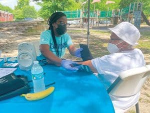 Team Member Taking Blood Pressure