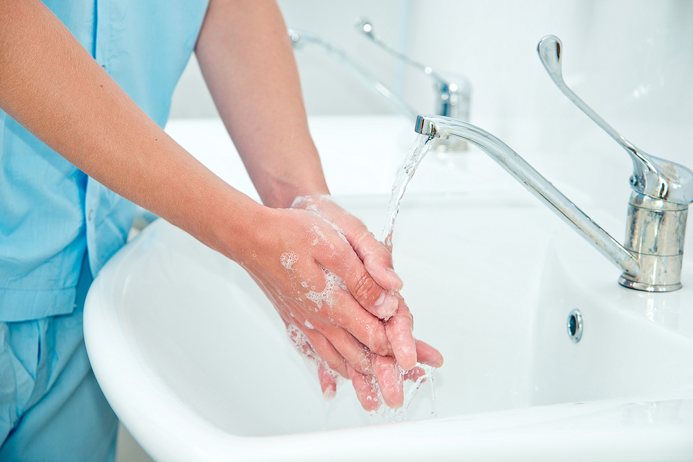 Nurse washing hands to prevent infection