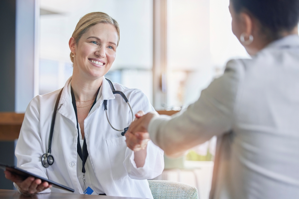 Nurse shaking hand of a co-worker to say thank you