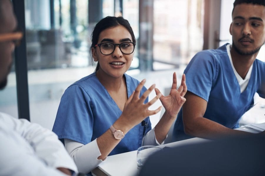 Nurse discussing domestic violence with colleagues