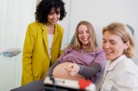 Lesbian couple with nurse