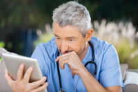 Nurse reading a Journal article
