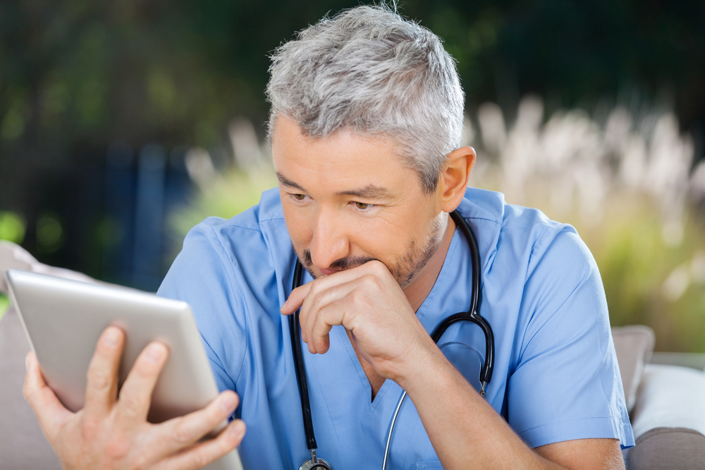 Nurse reading a Journal article