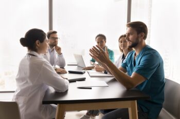 nurse leading meeting