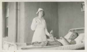 An unnamed nurse cares for a soldier at Fort Bayard Military Hospital circa 1917. Fort Bayard’s nurses in some ways represent the arrival of western medicine to Grant County. Although many photos of nurses at Fort Bayard exist, few, if any, are named (From the Silver City Museum Archive #01363).