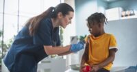 Nurse giving a child a COVID-19 vaccine