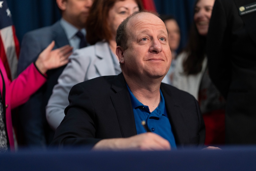 May 1, 2025: Gov. Jared Polis prepares to sign a bill at the Colorado Capitol in Denver.